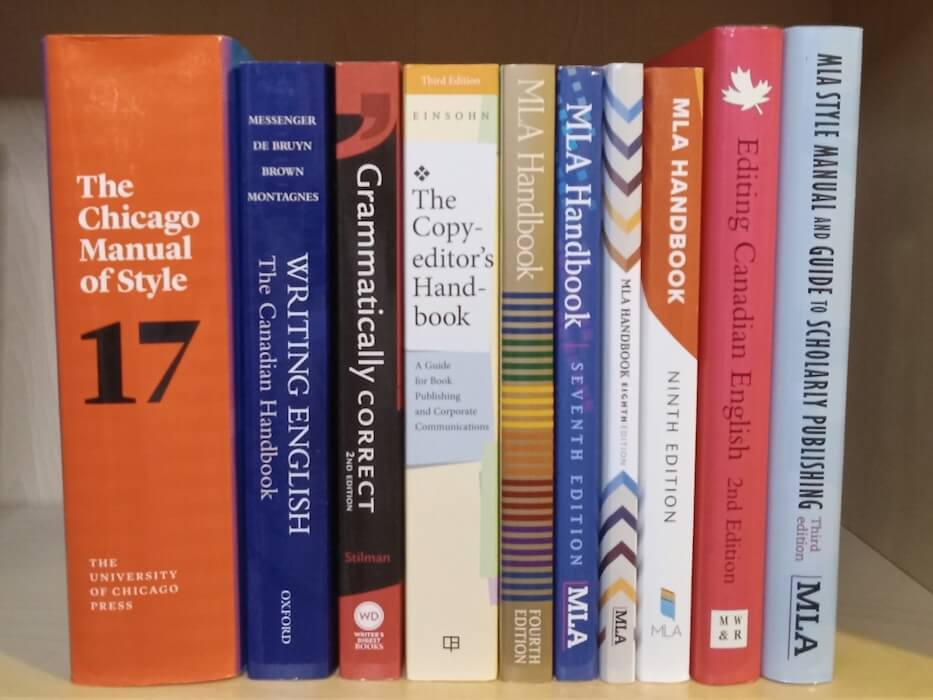 Photo of the spines of several reference books (including The Chicago Manual of Style and several editions of the MLA Handbook) on a shelf.